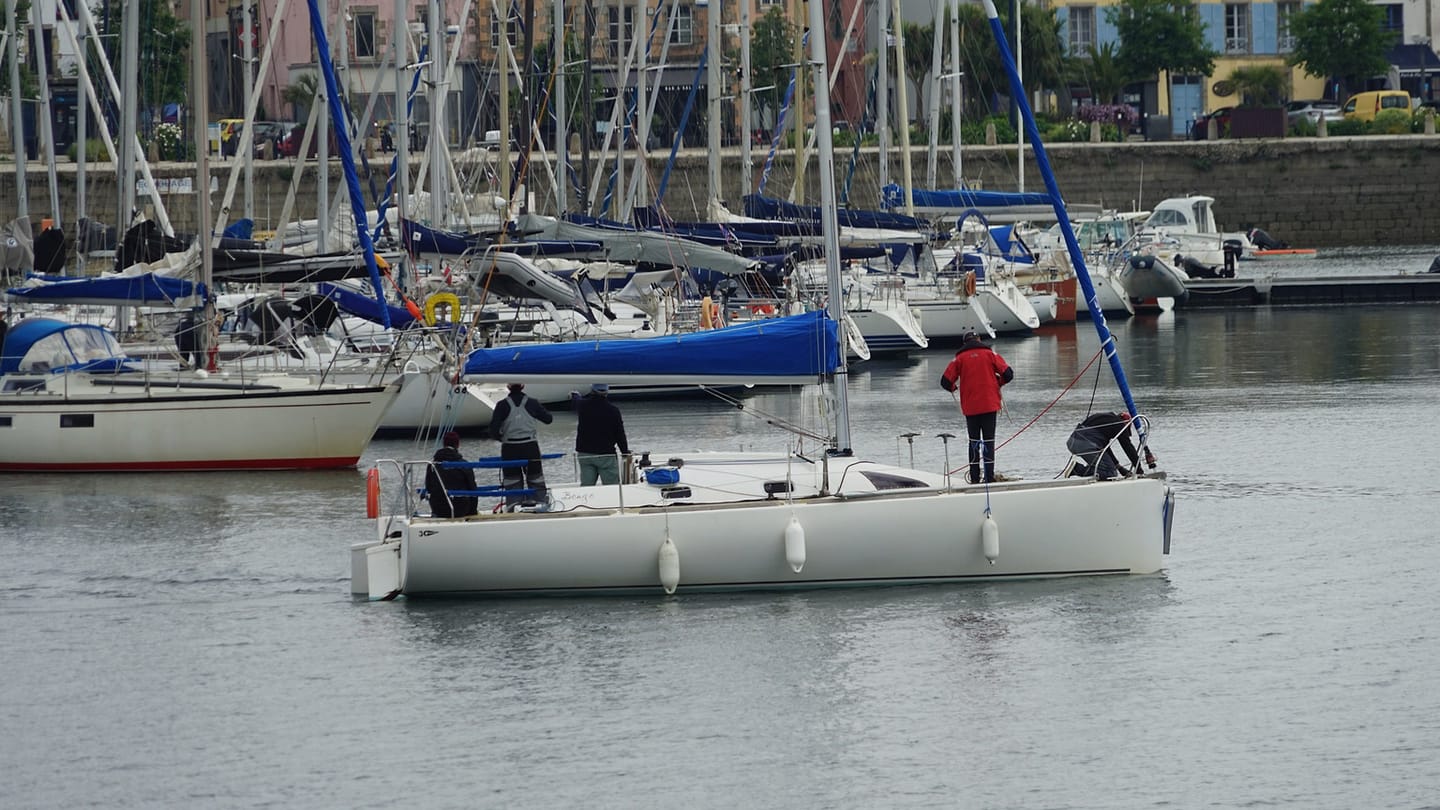 Sailors working together in the cockpit of a yacht