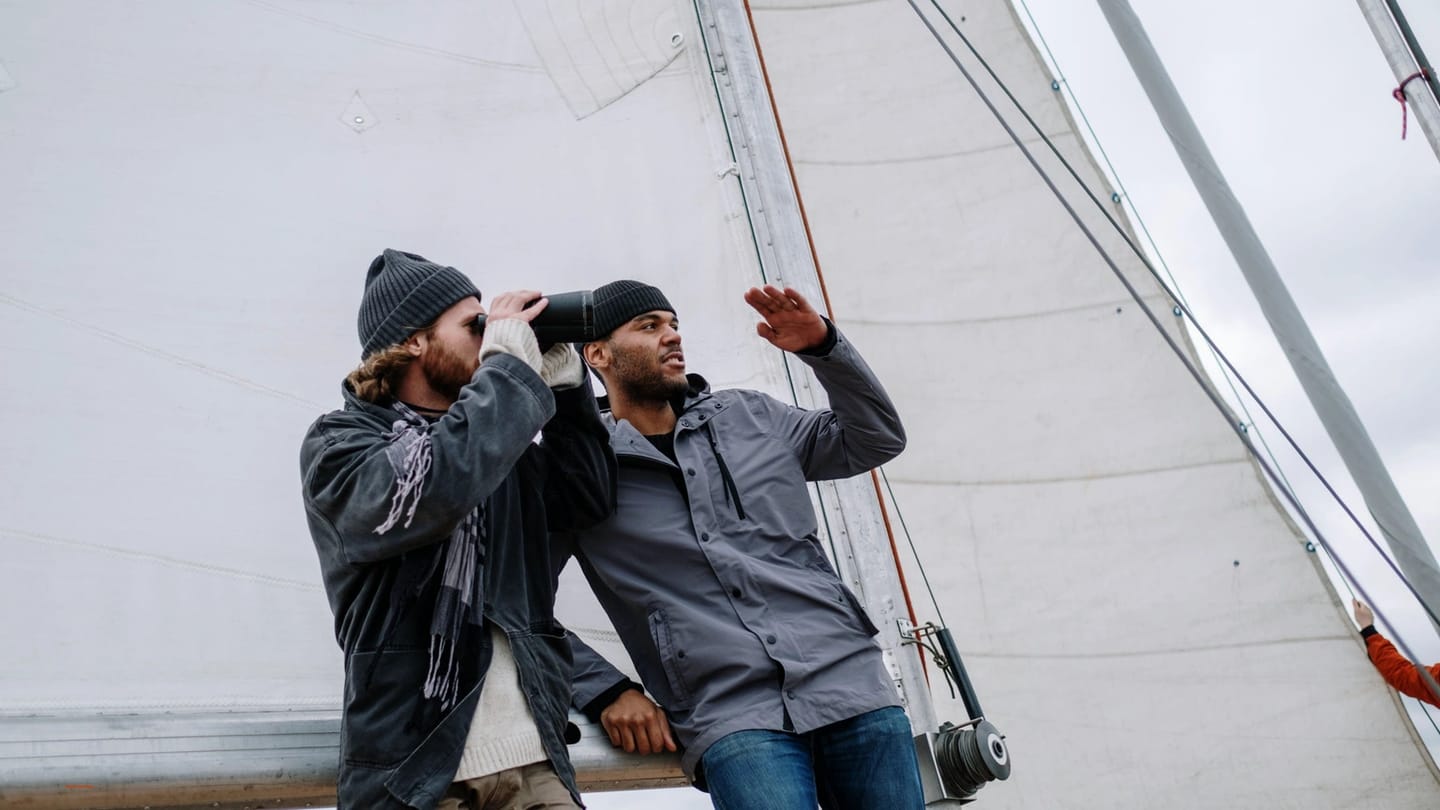 Sailors discussing the next task beside the mast