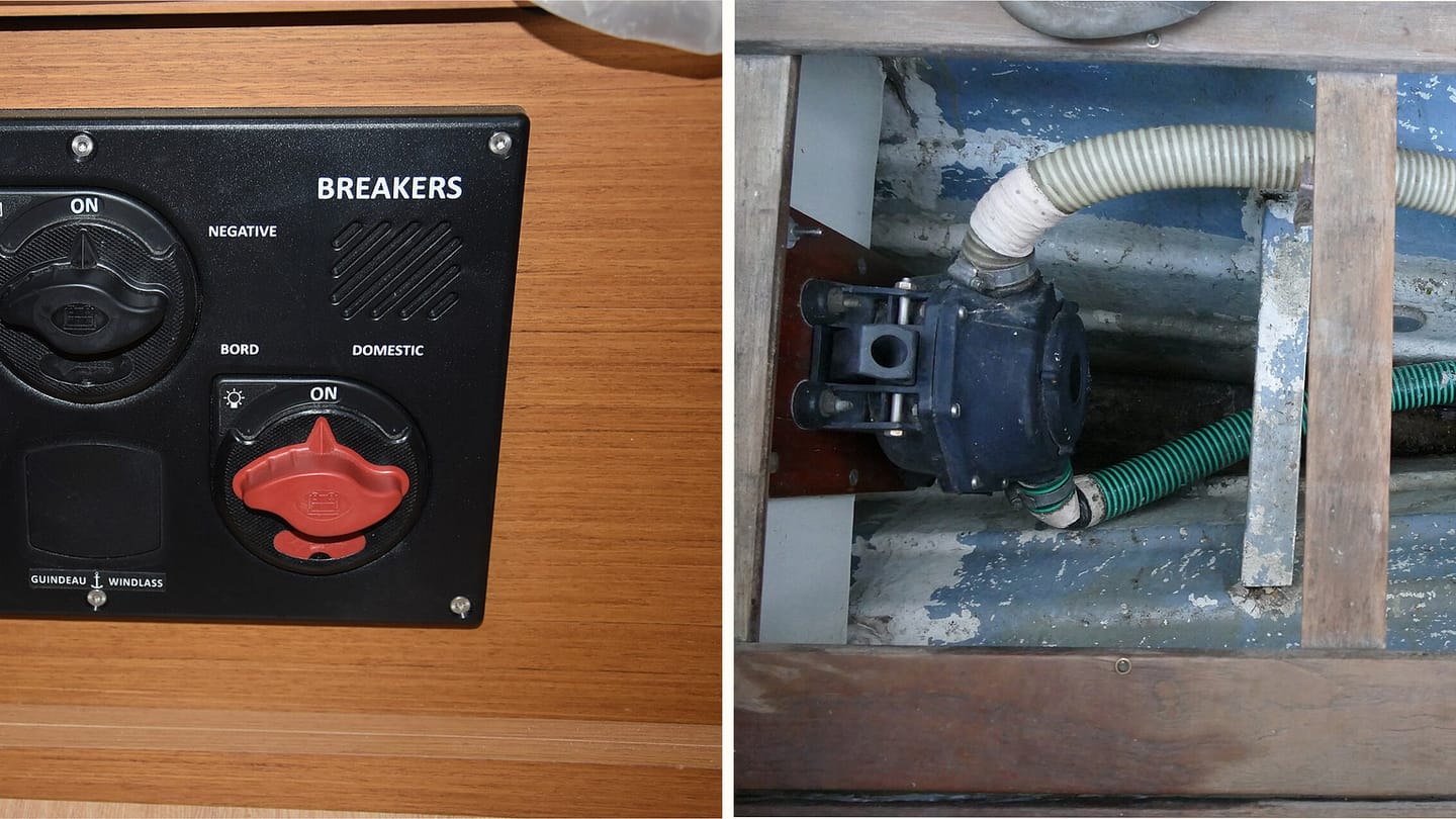Main sailboat battery switches beside an installed bilge pump and hoses