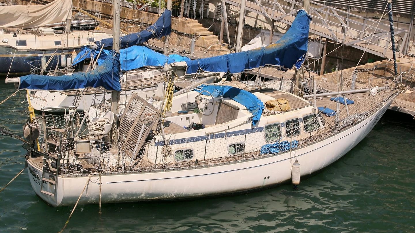 Used cruising sailboat moored in a marina