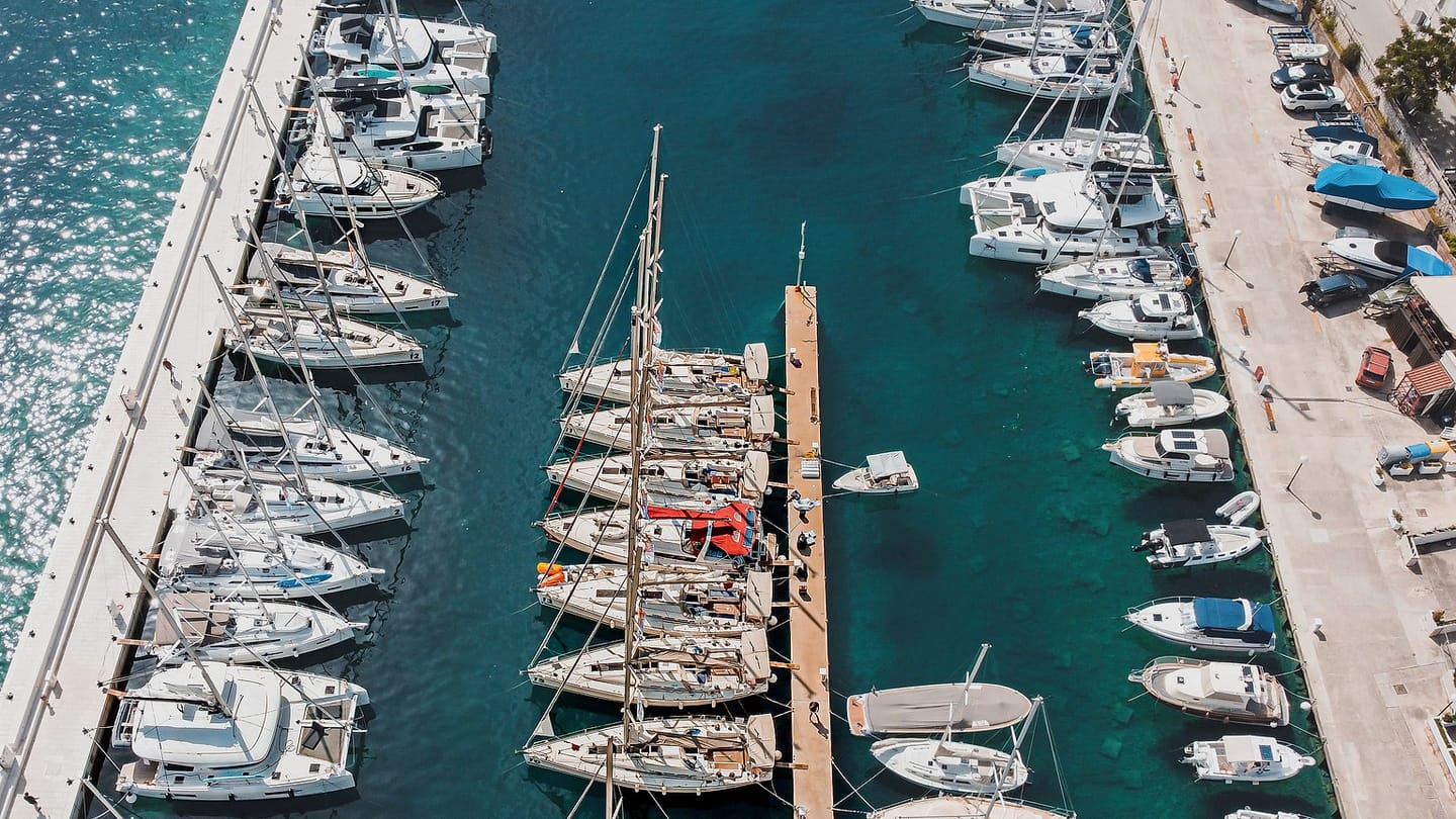 A broad, calm marina offers protected water for a gentle first sailing session.