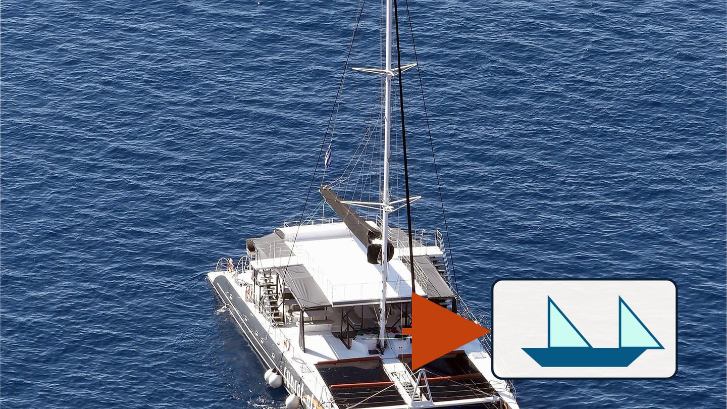 An aerial view of a wide cruising catamaran with a twin-hull boat symbol