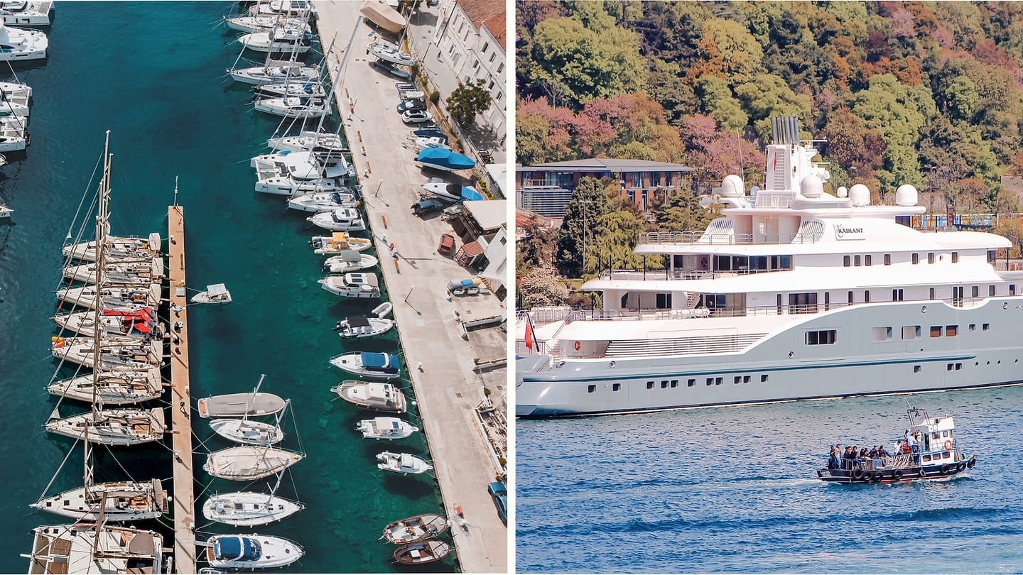 Sailboats and a large yacht sharing marina space