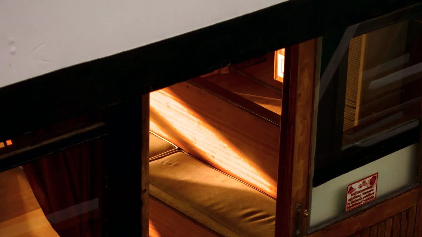Wooden seating and windows inside a boat cabin