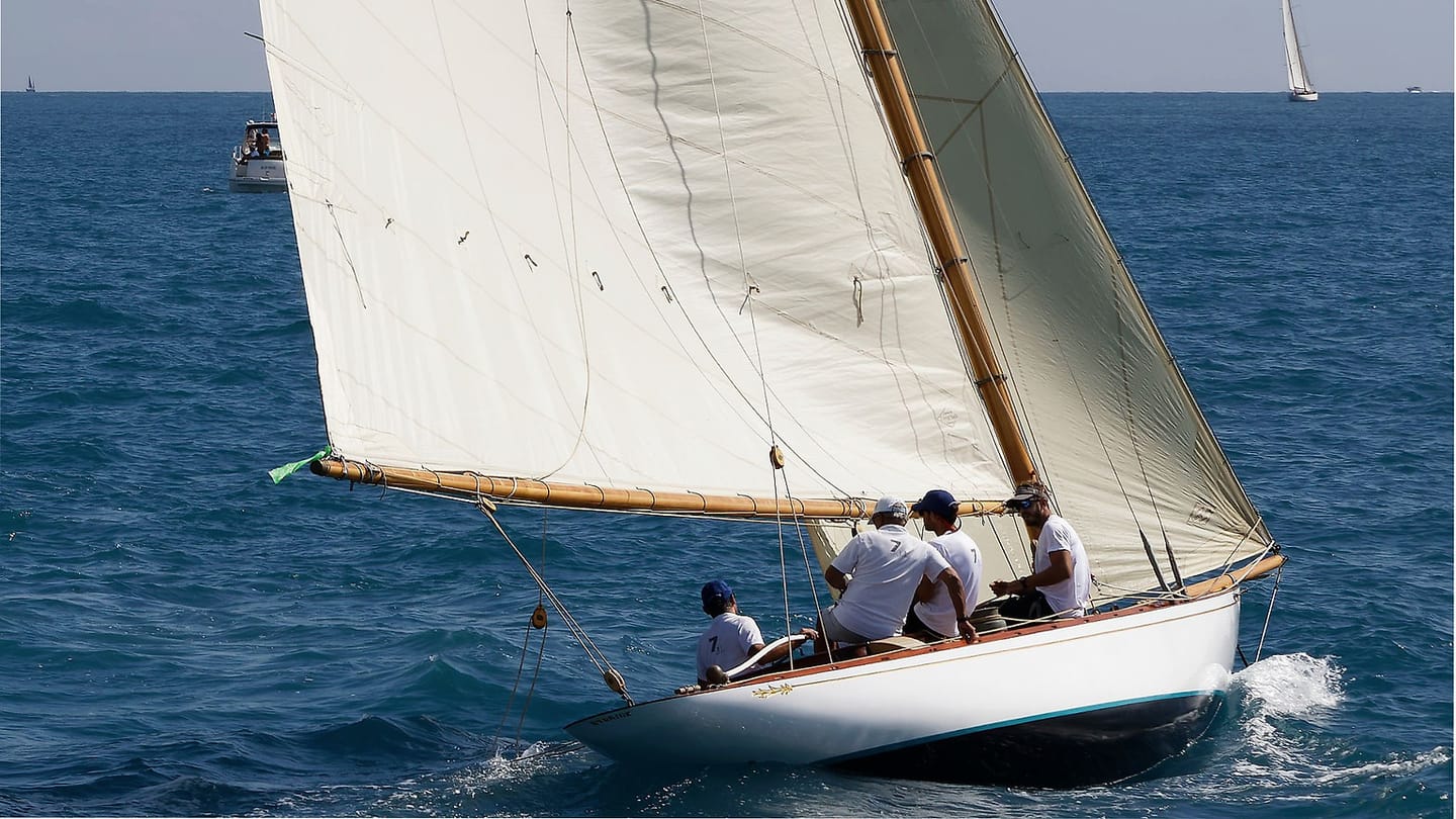 Crew sailing a cruising boat across open water