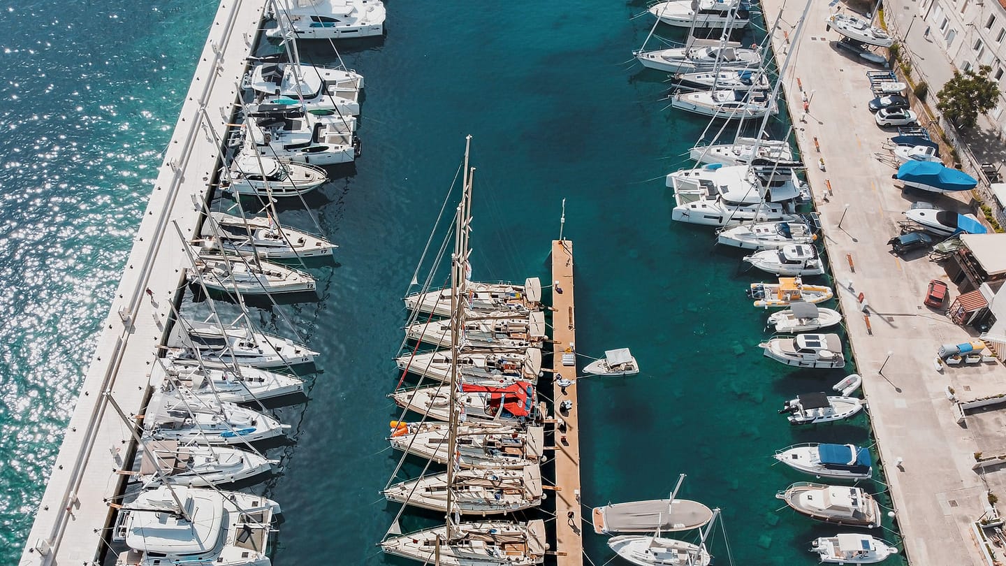 An aerial marina view shows fairways, docks, and water where local forces can vary.