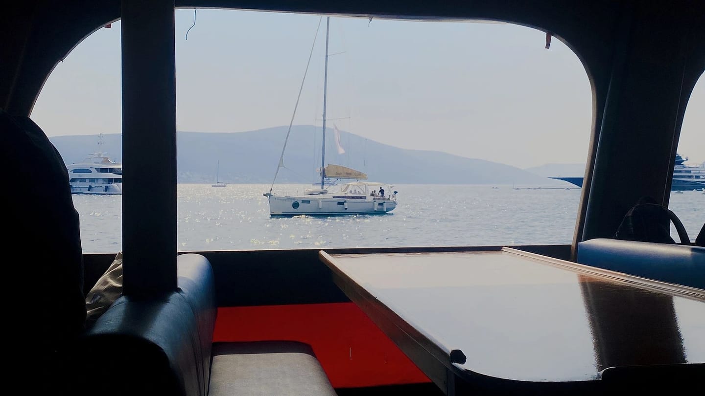 View from a yacht cabin across calm water