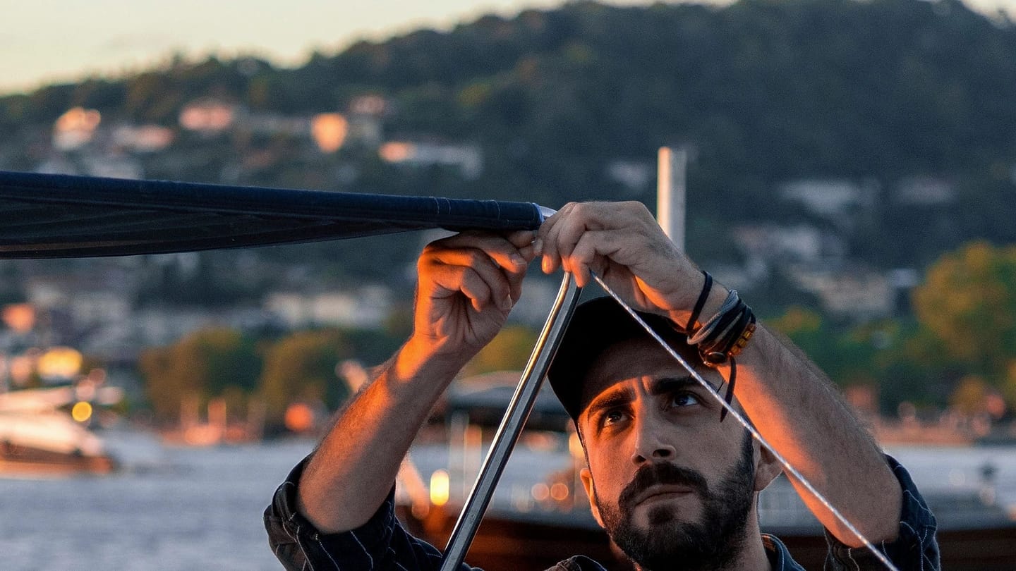 Person checking equipment aboard a moored boat
