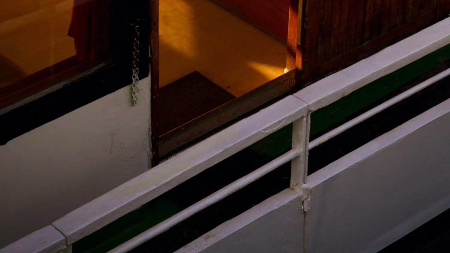 Open companionway hatch on a sailboat deck leading down into the cabin interior