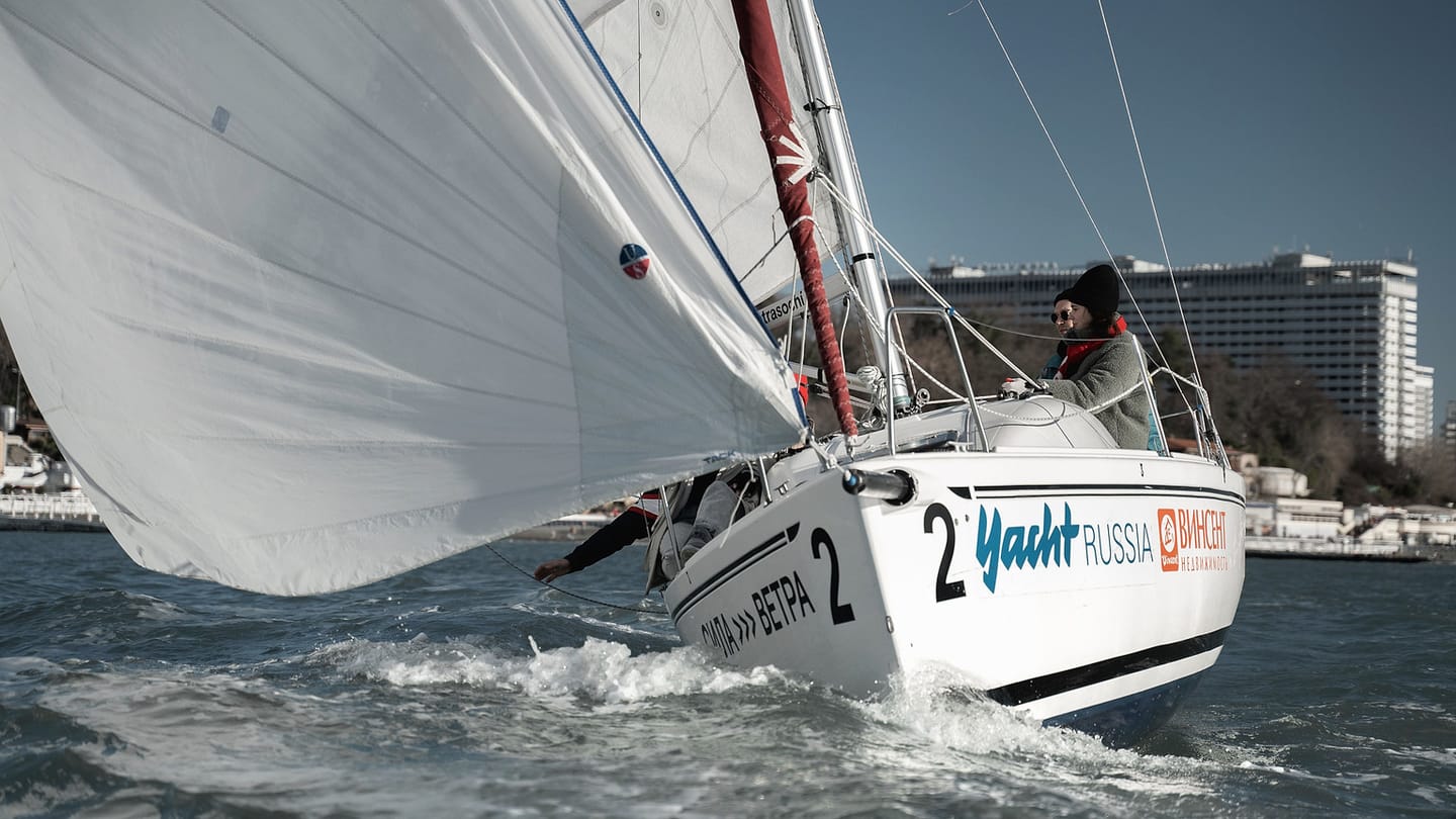 A sailor aboard a small sailing boat demonstrates the scale of a centerboard dinghy recovery.