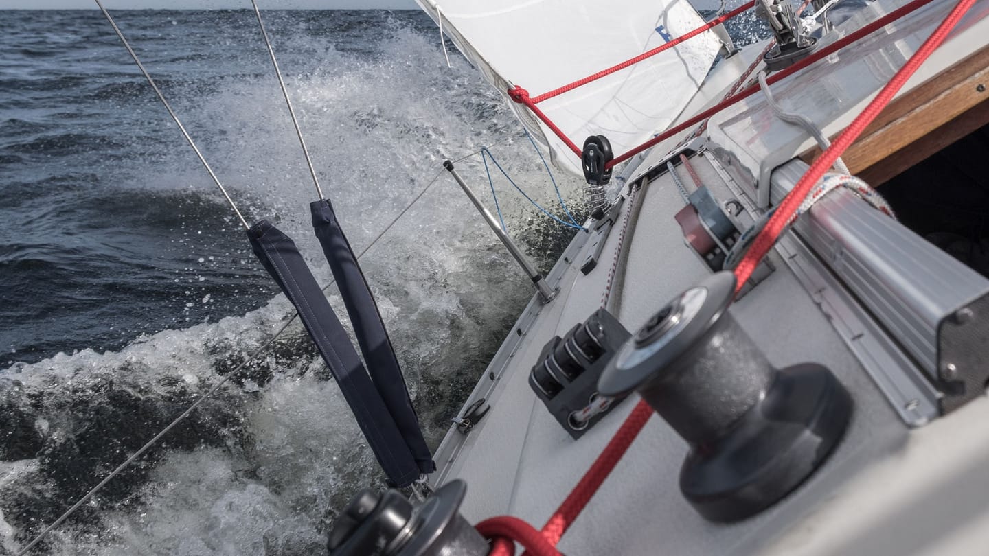 A sailboat moving through choppy water under sail