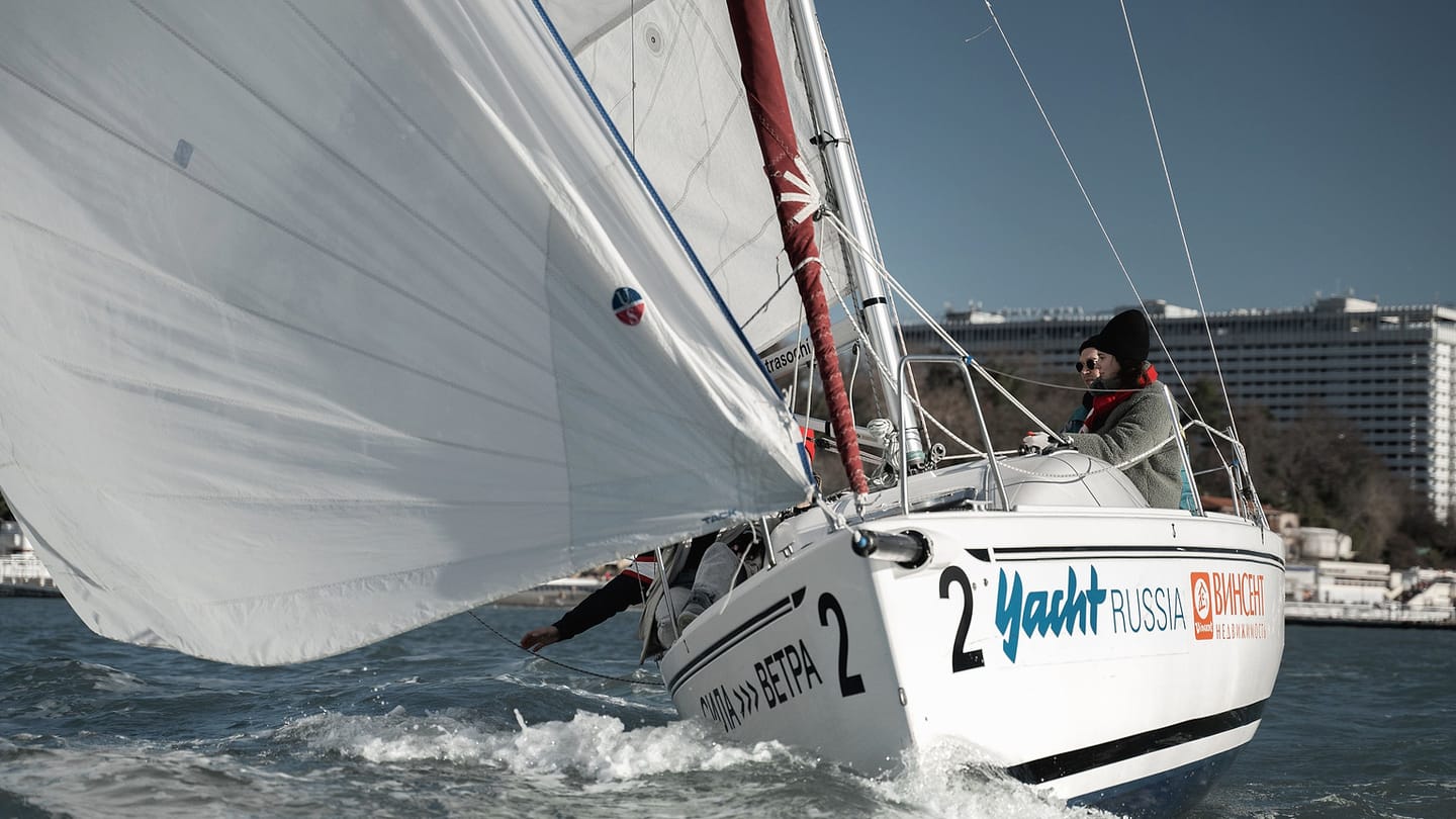 A yacht sails with a clear view of its mainsail and the water around the hull.