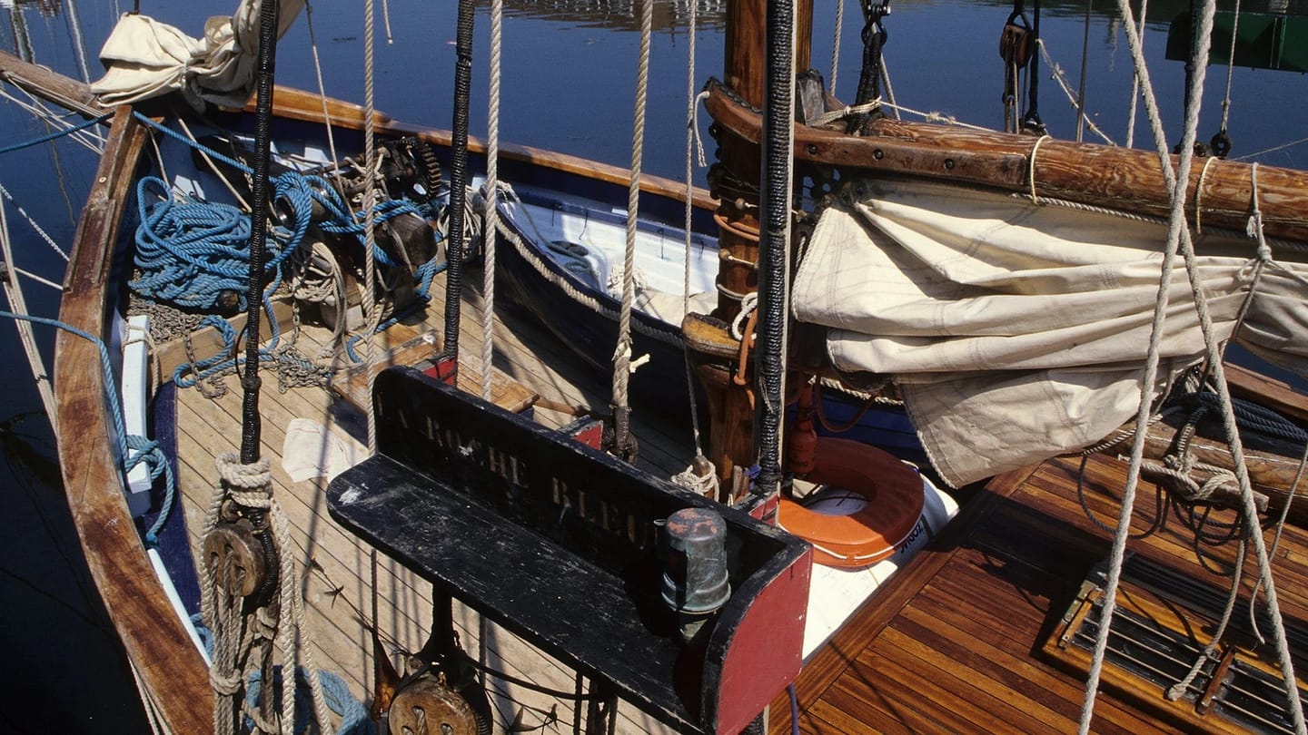 Sunlit wood and rigging on a vintage sailboat