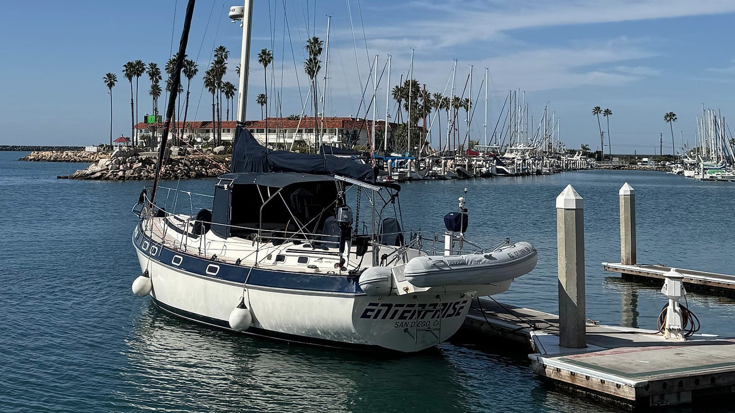 A moored sailing yacht can be inspected at the dock after severe weather.