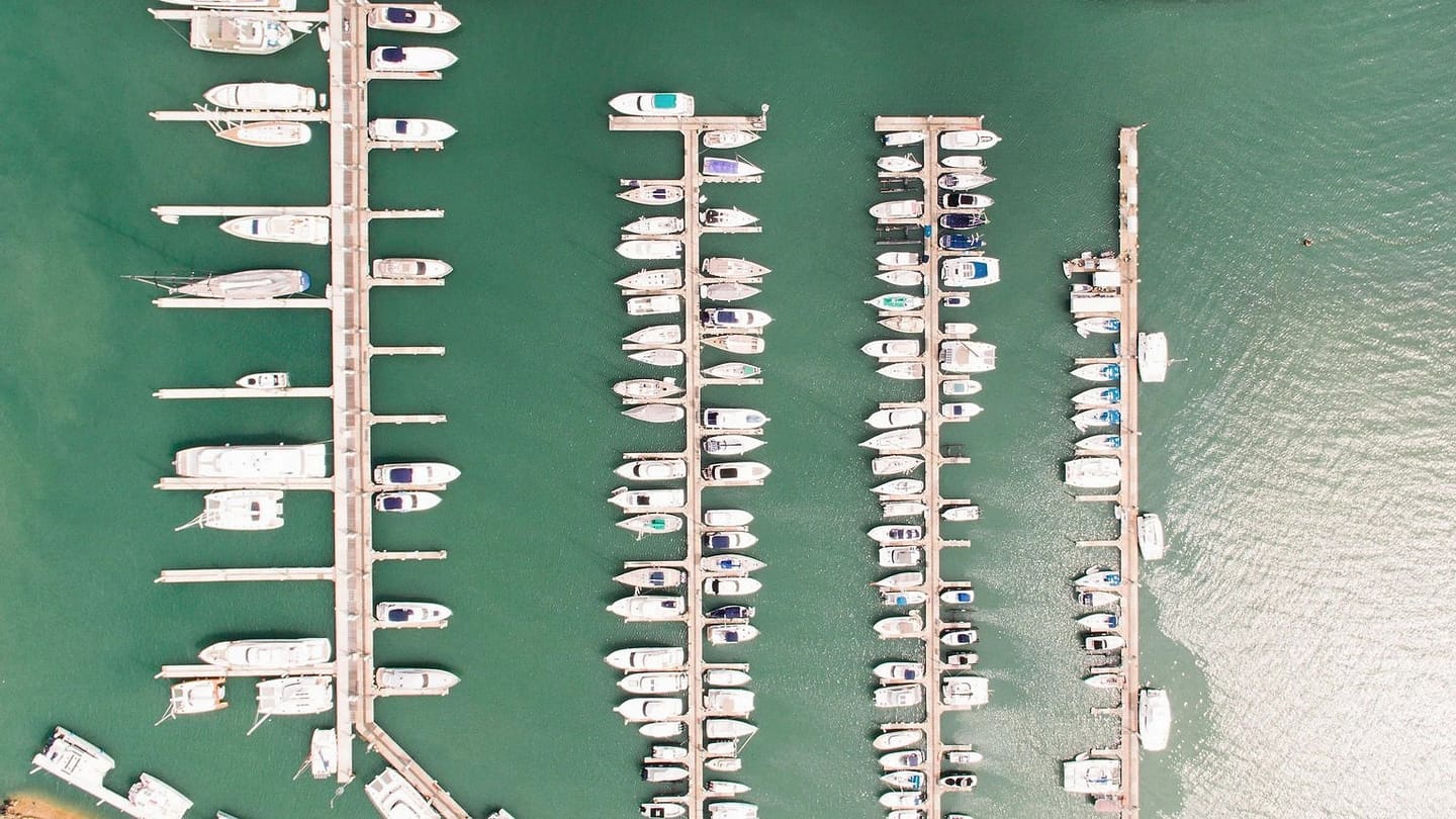 Aerial view of boats arranged in marina slips