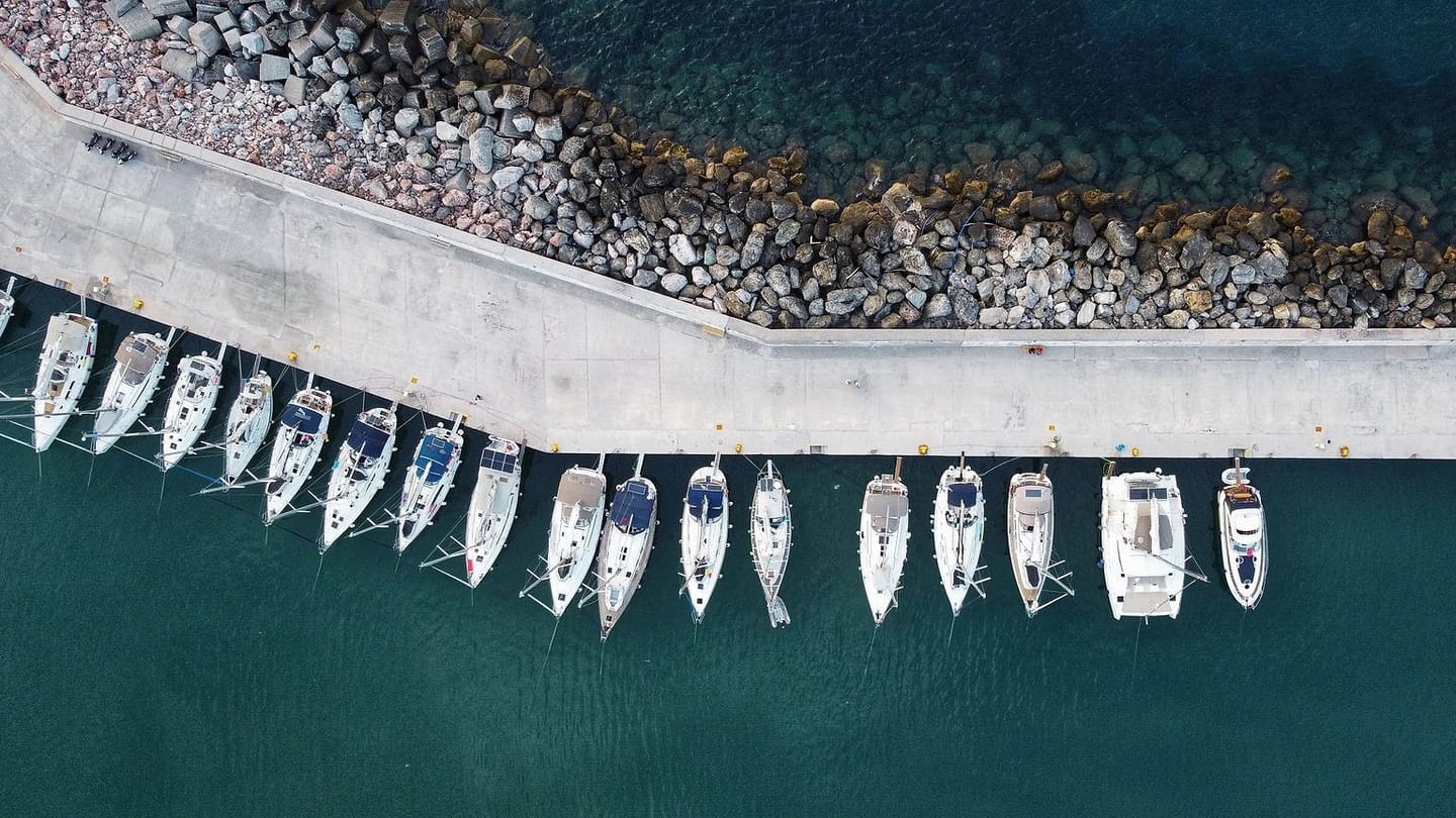 Sailboats moored along the quay in a Greek island harbour