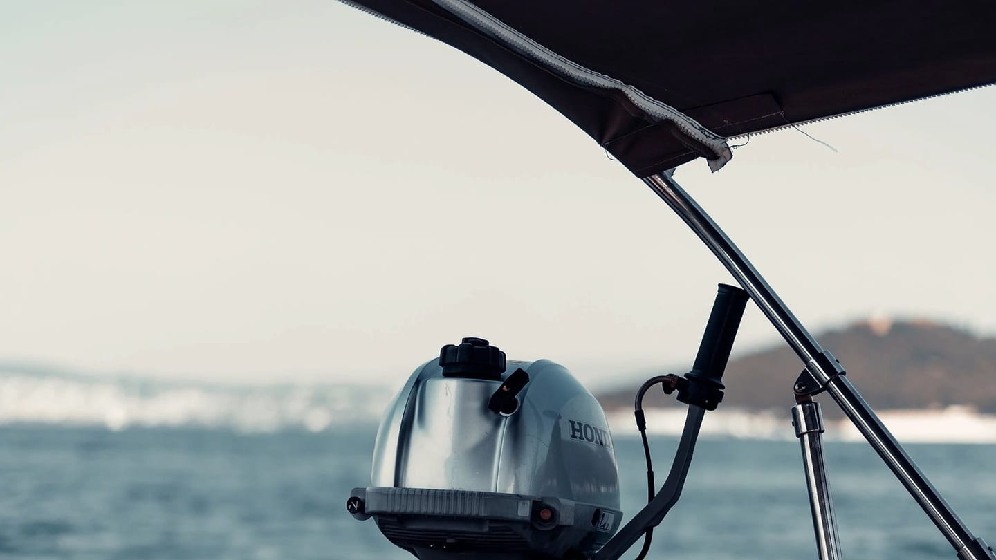 Outboard motor mounted on a small boat at sea