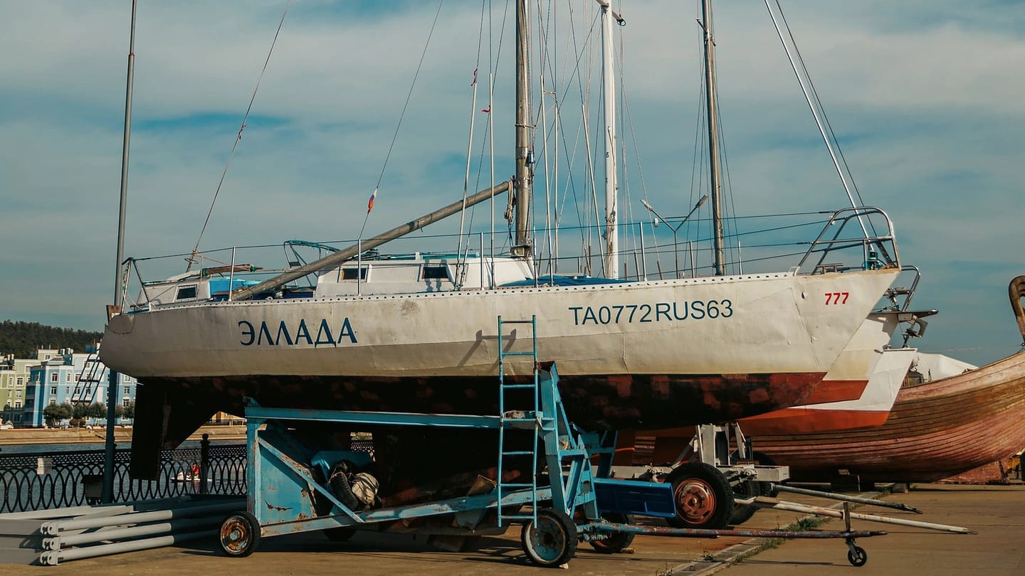 Sailboat standing ashore beneath a blue sky
