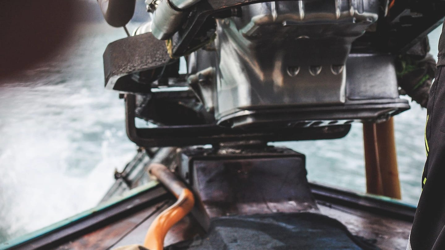 Mechanic handling an engine aboard a boat