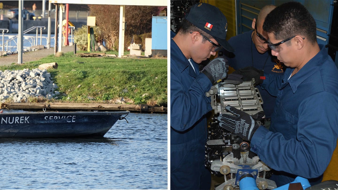 Small motorboat and technicians working on an engine