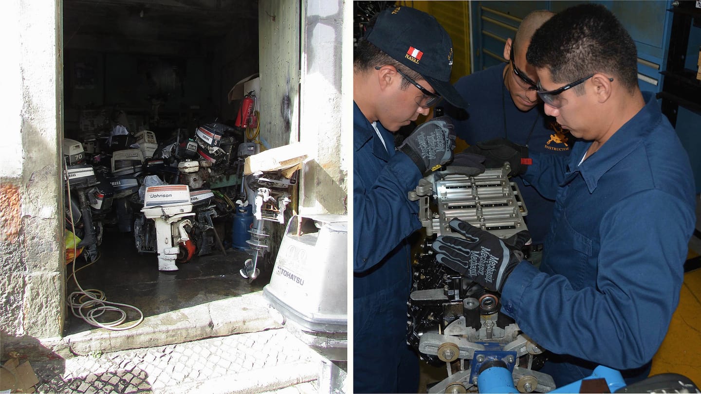 Outboard repair shop beside technicians servicing an engine assembly