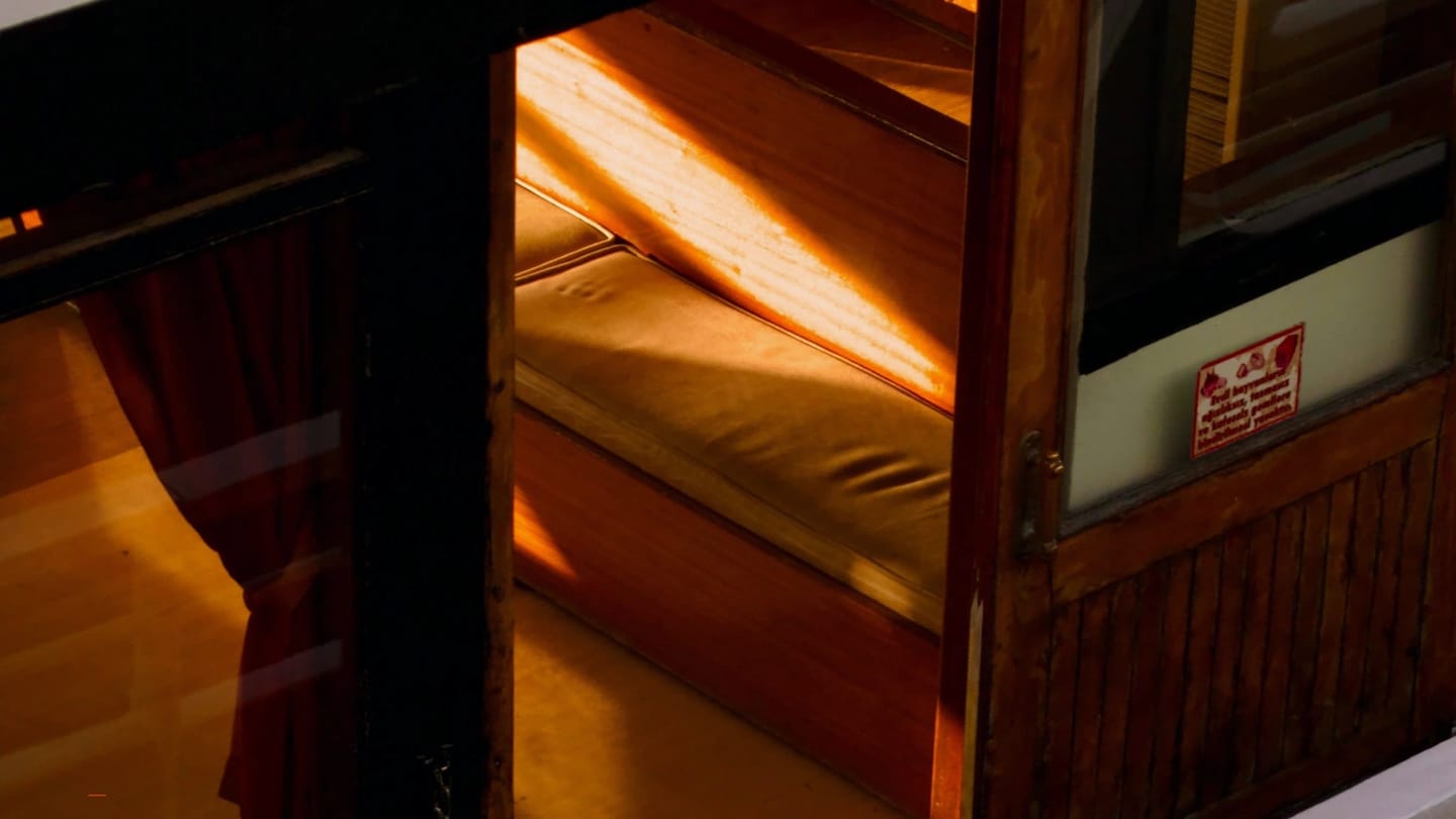 Compact cabin berths prepared for rest aboard a yacht