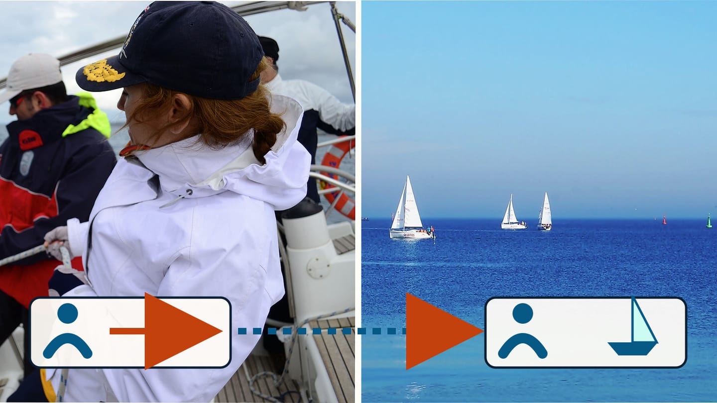 A sailor working aboard a yacht beside sailboats underway on open water
