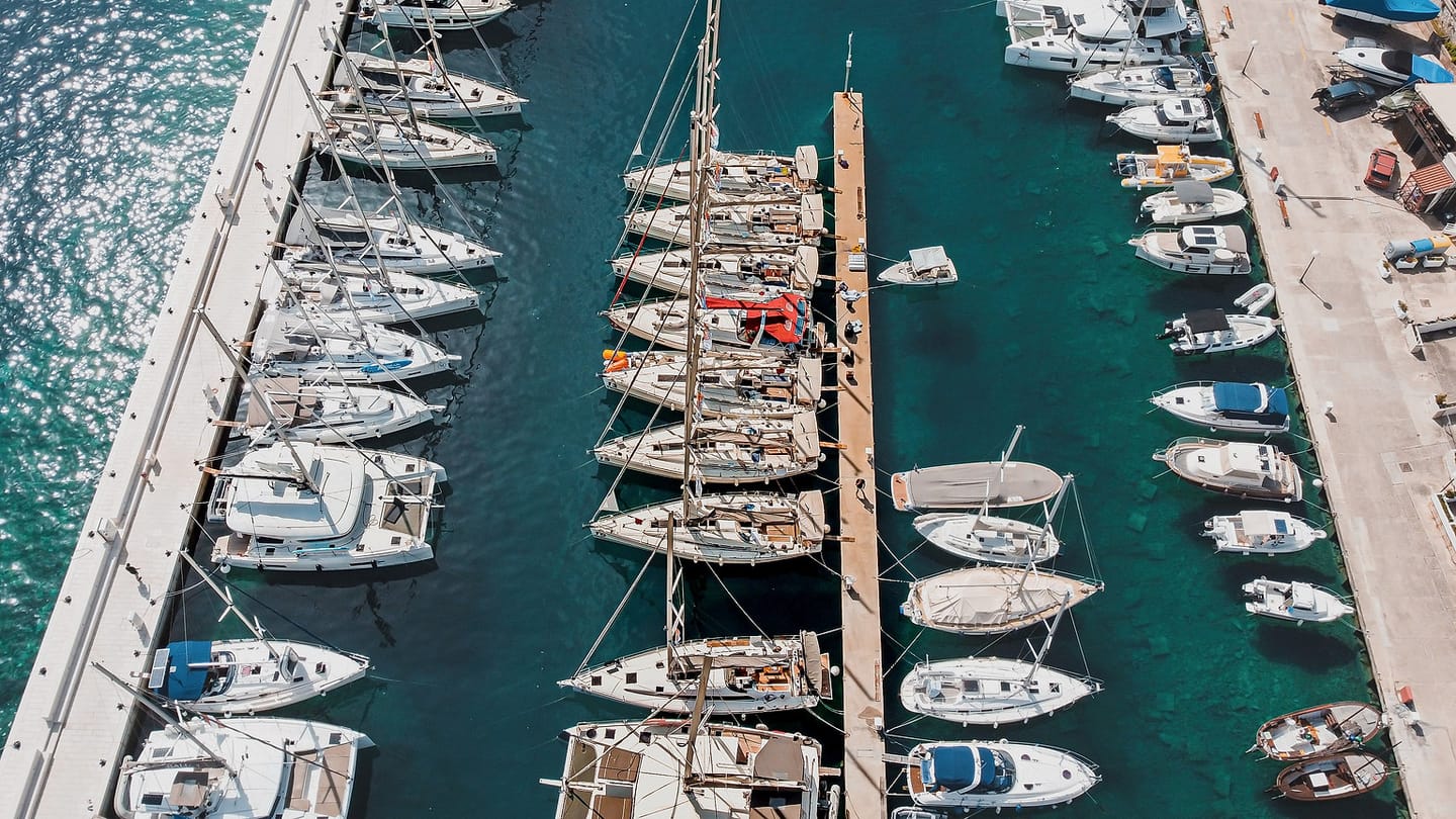 A clear-water marina seen from above makes the space between hulls and bottom easier to imagine.