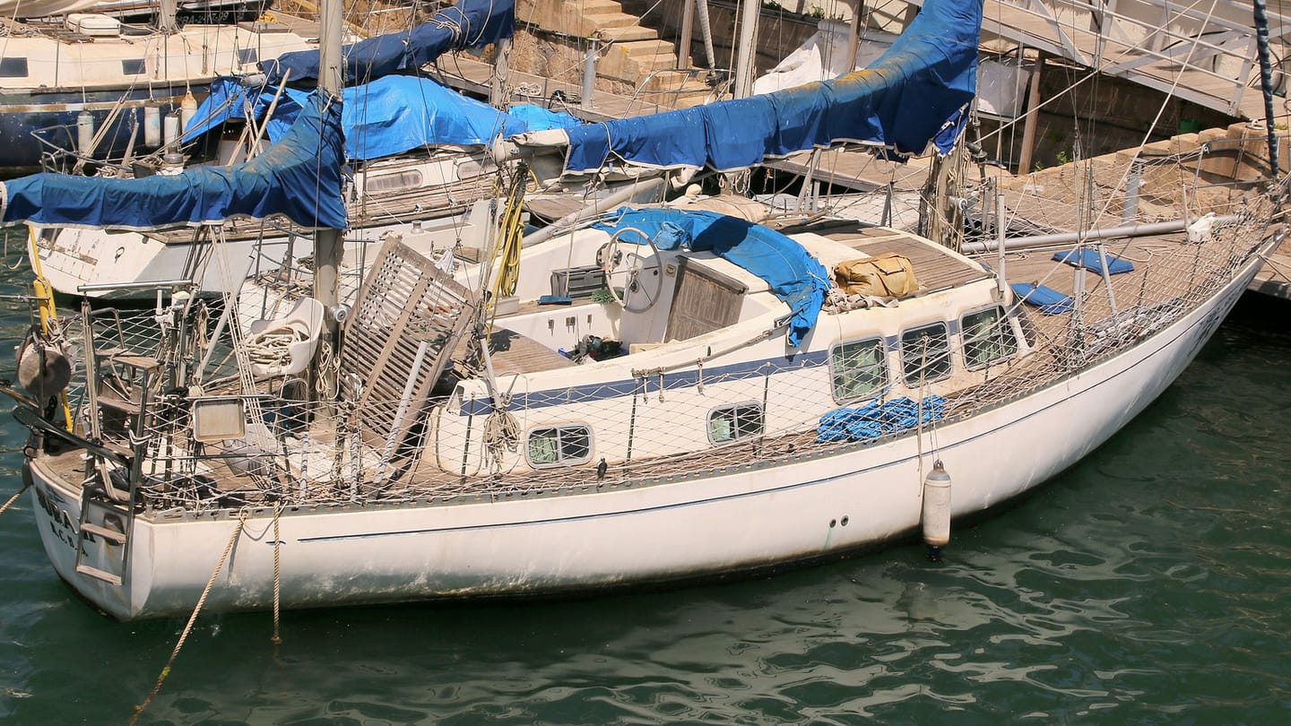 A sailing yacht's hull sits in the water with its deepest structure hidden below.