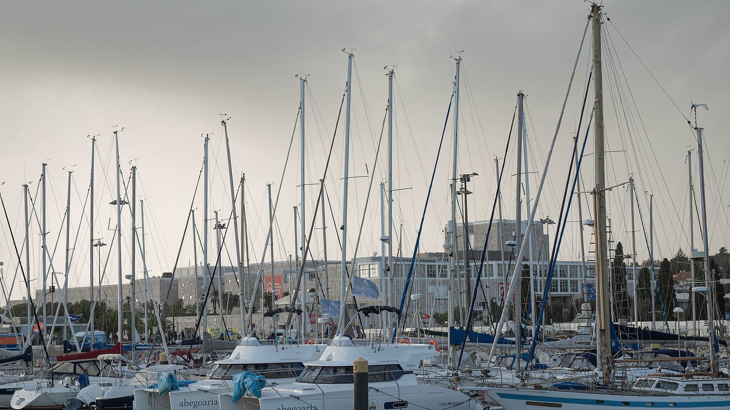 Sailboats in a marina occupy water whose depth varies across fairways and berths.