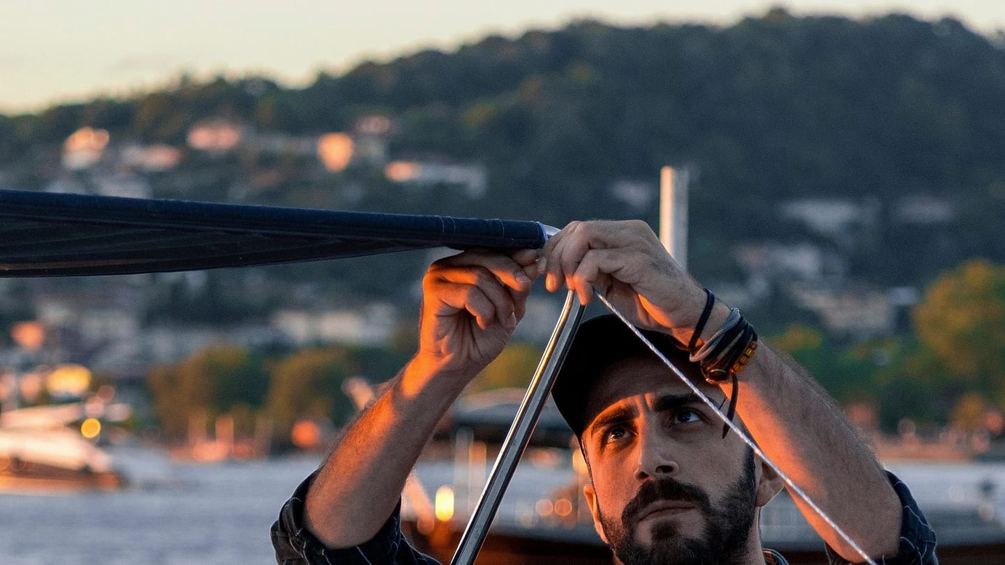 Person working under a canopy aboard a boat