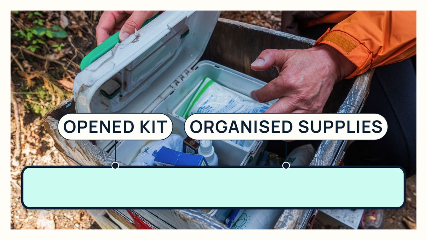 Hands opening a real first-aid kit to reveal organised dressings and tools
