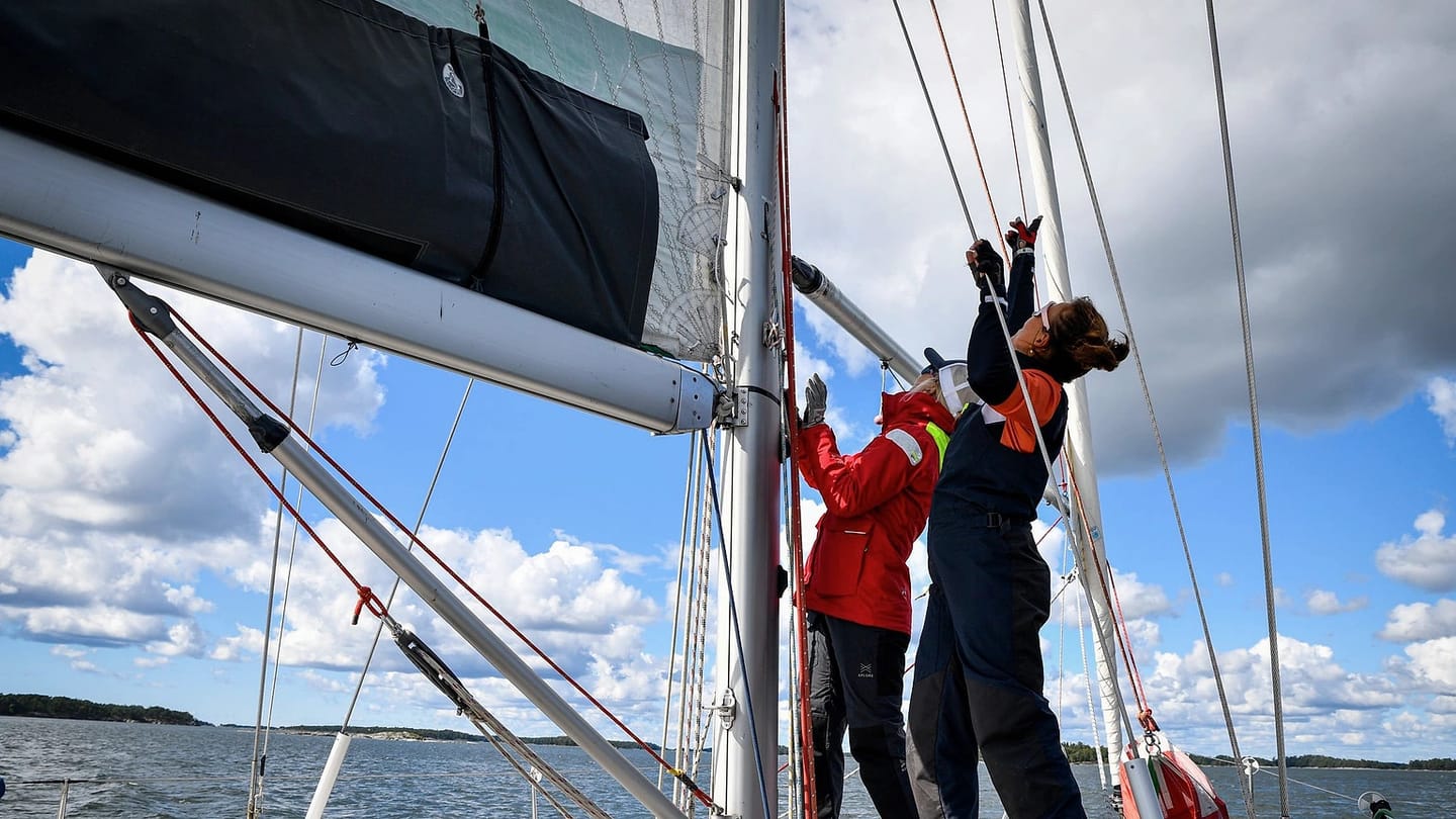 Crew sailing a yacht on open water