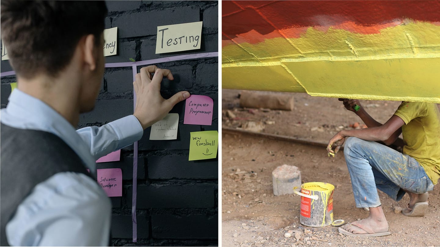 Project planning board beside a worker painting a boat hull
