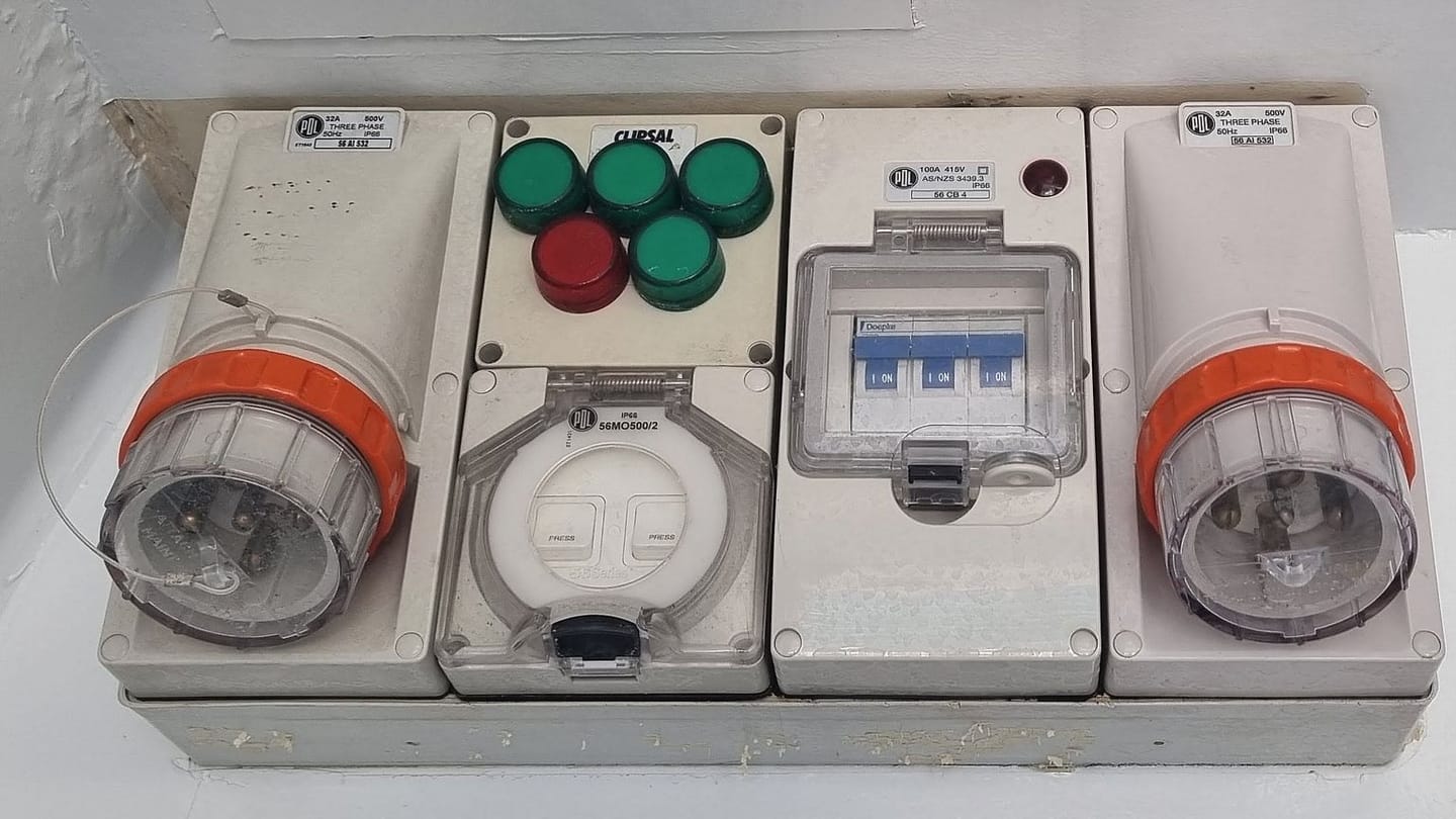 Two covered shore-power inlet sockets on a vessel