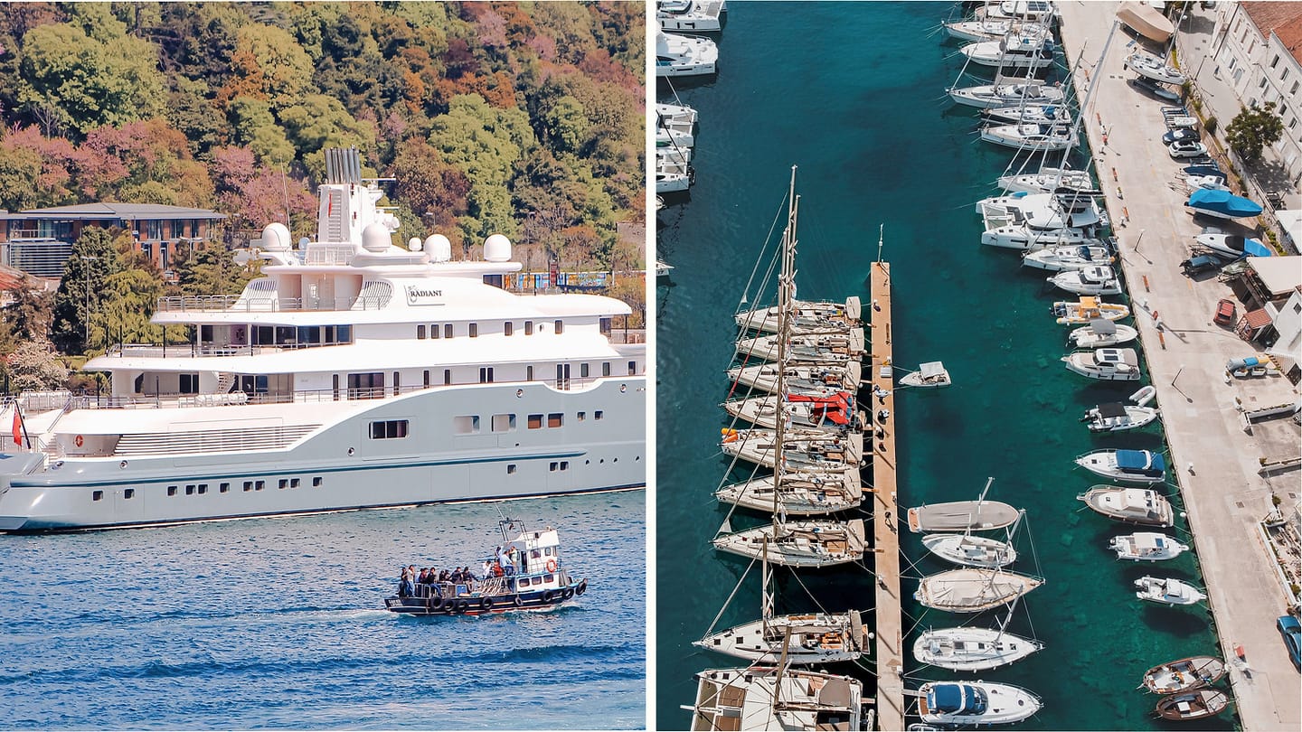A large motor yacht and smaller boats in a marina