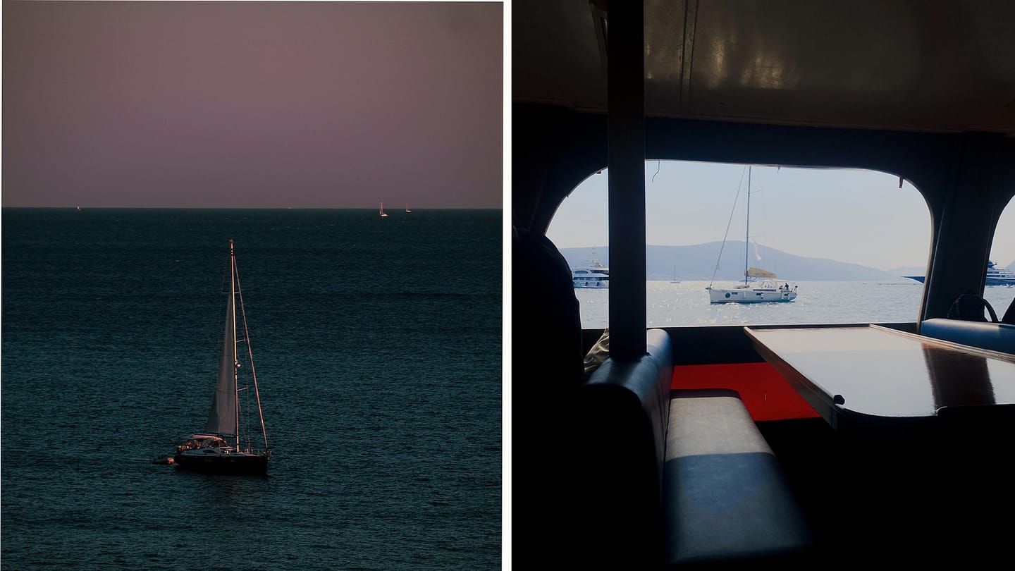 Sailboat at sea viewed from a cabin workspace