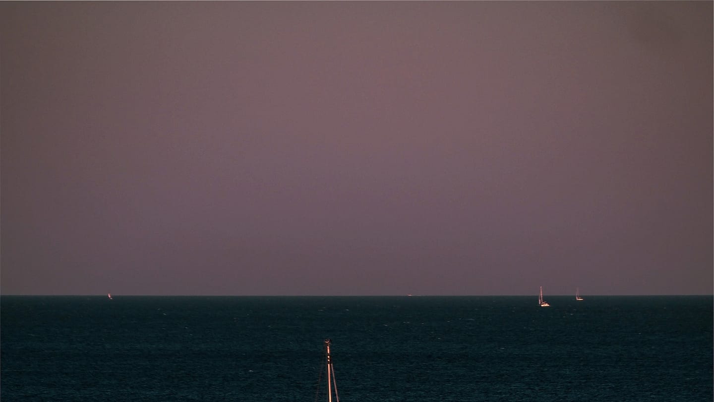 Sailboat underway while navigation and weather are logged