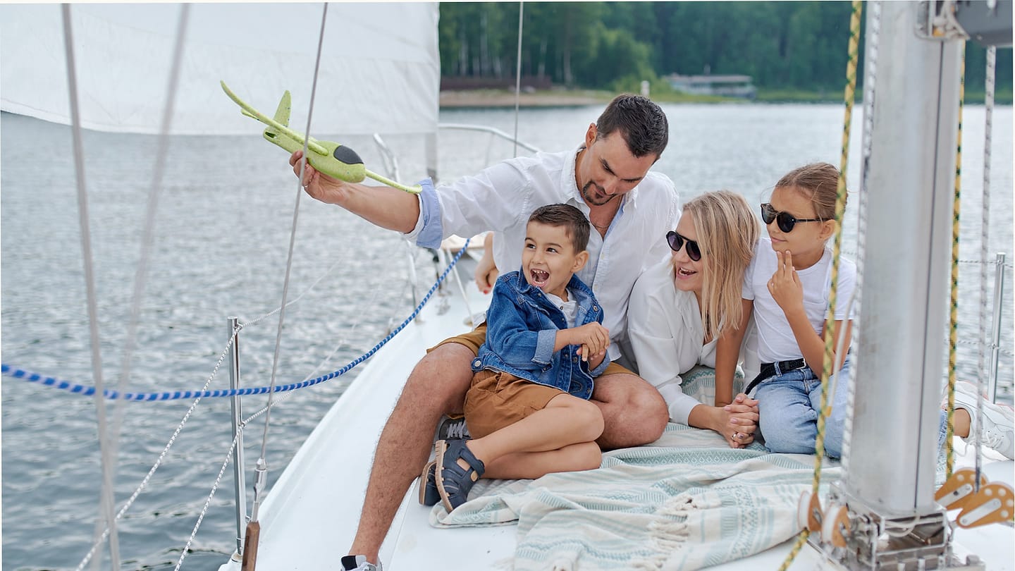 A family sharing the cockpit of a sailing boat