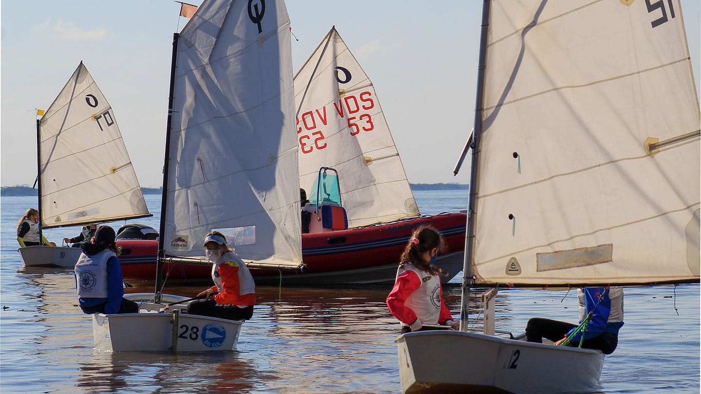 Children sailing small boats on calm water