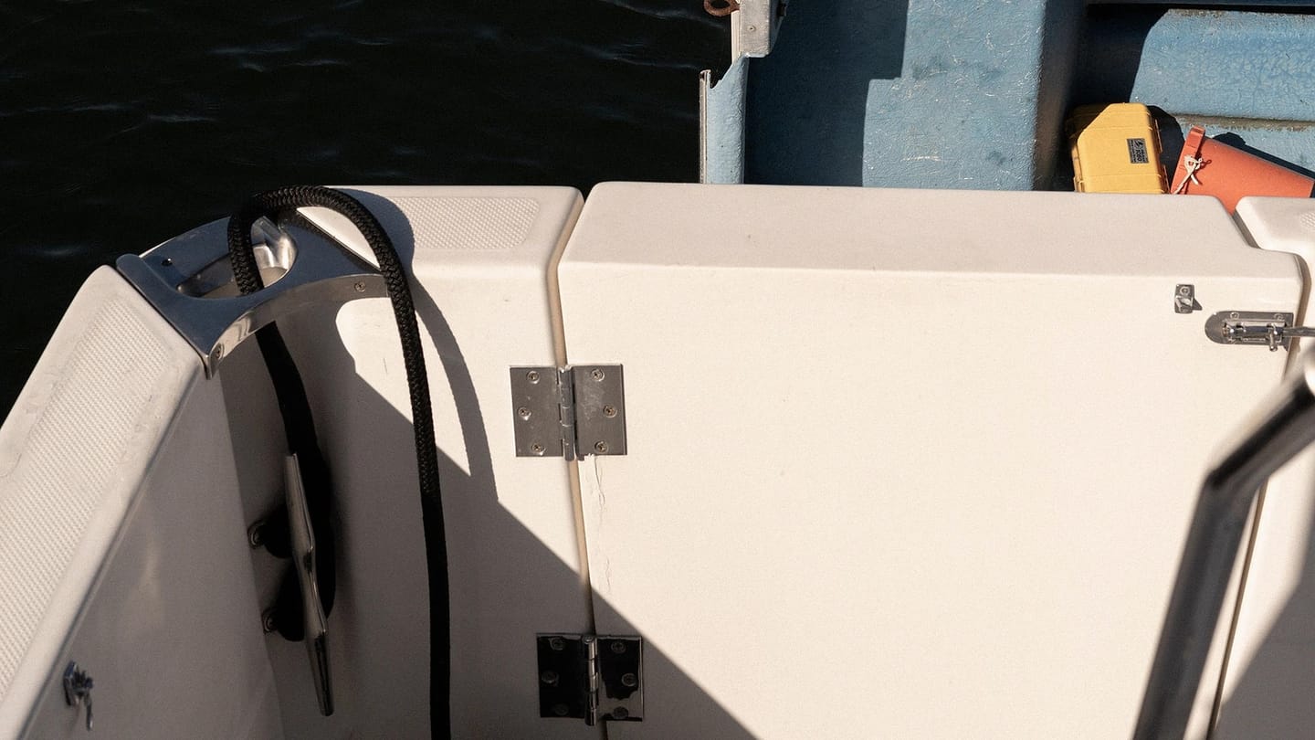 Clean sailboat deck beside calm water