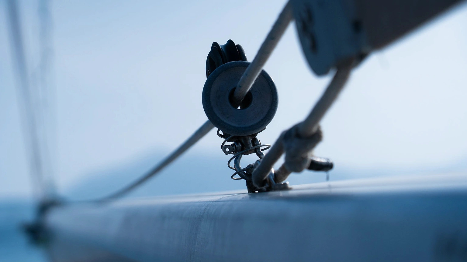 Close view of a sailboat pulley and line