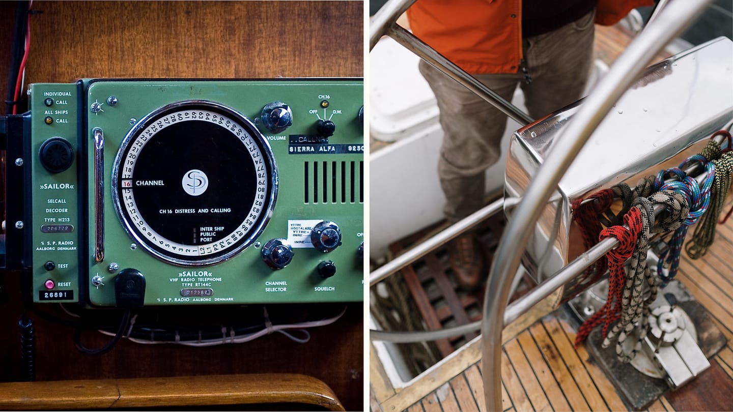 A fixed marine VHF radio beside lines and metalwork on a sailboat deck