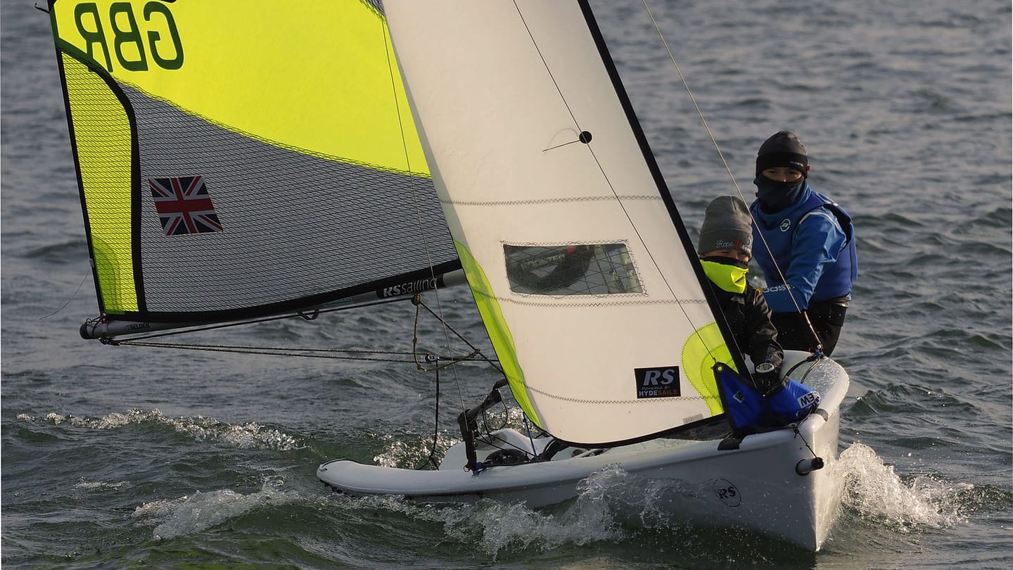 Sailors working together during a club sailing event
